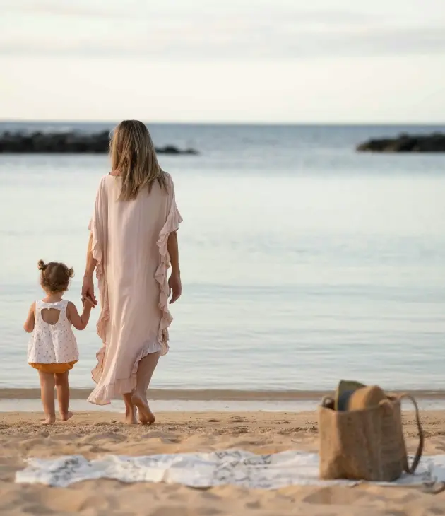Family walking together on the beach at Veranda Pointe aux Biches