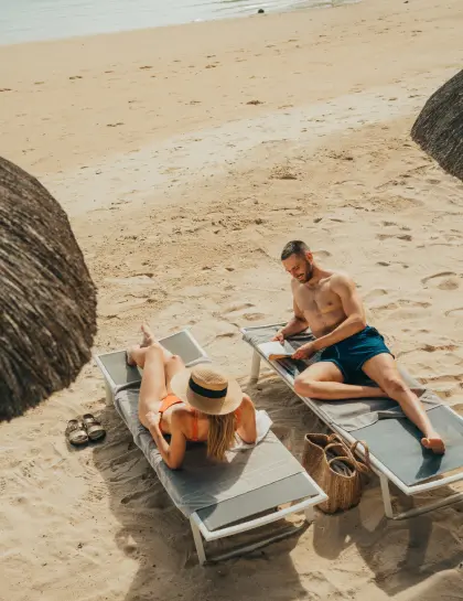 couple on beach relaxing holidays at veranda resorts mauritius